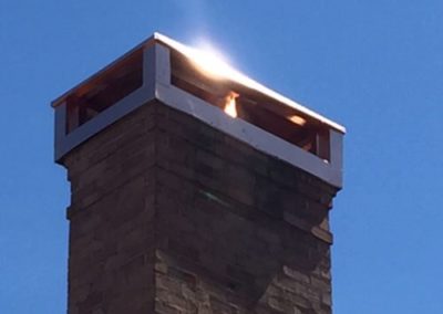 Copper chimney cover with red brick chimney