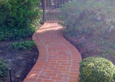 Custom red brick path with fencing