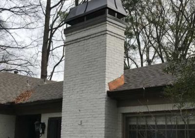 White brick chimney with large cap