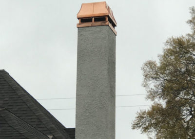 Stucco chimney with elegant copper cap