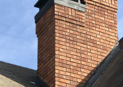 Double brick chimney with black cap