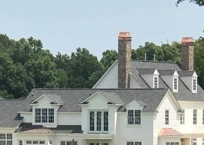 Custom copper chimney covers on homes